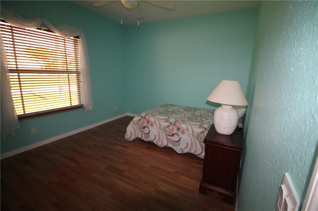 168 Southwest Ridgecrest Drive Port St. Lucie, FL 34953 - Photo 15 of 17 a bed sitting in a bedroom next to a window