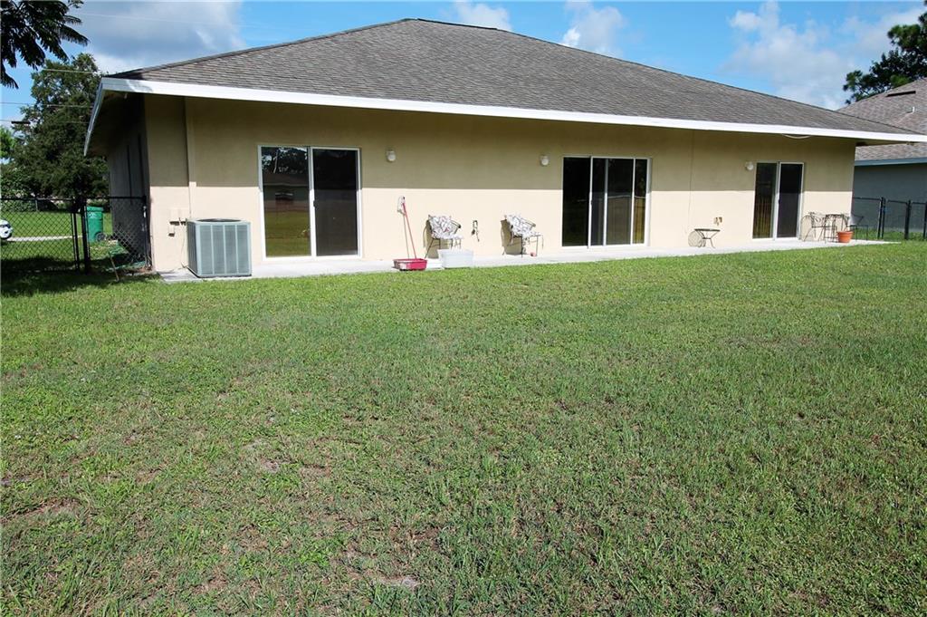 168 Southwest Ridgecrest Drive Port St. Lucie, FL 34953 - Photo 16 of 17 a front view of a house with a yard