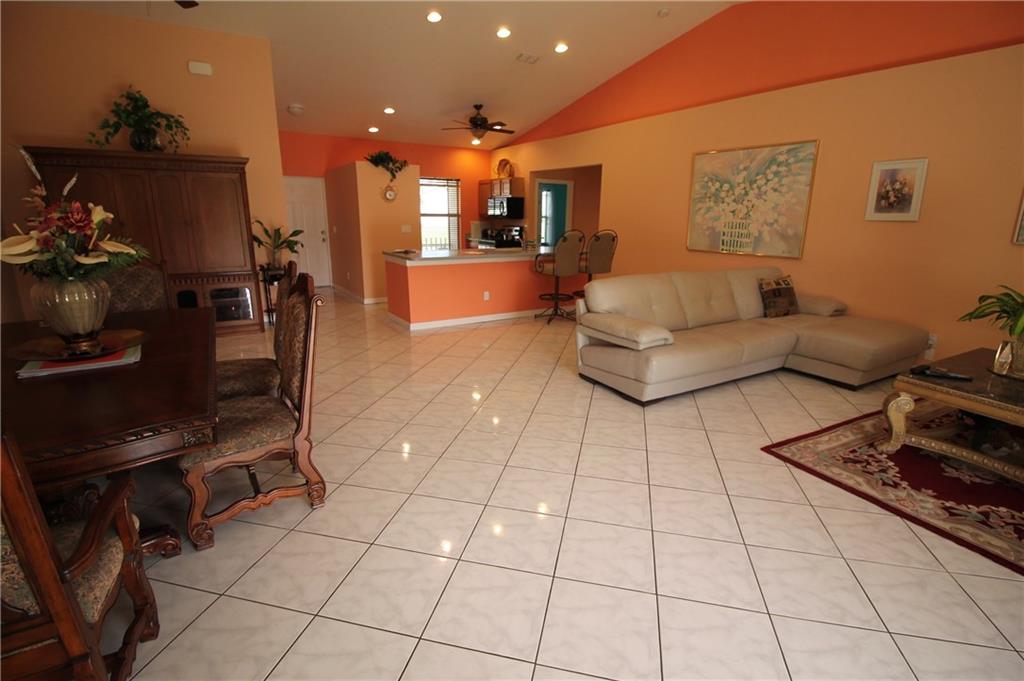 168 Southwest Ridgecrest Drive Port St. Lucie, FL 34953 - Photo 4 of 17 a living room with furniture and a flat screen tv