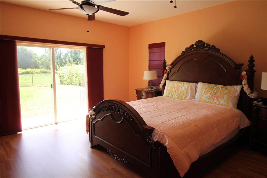 168 Southwest Ridgecrest Drive Port St. Lucie, FL 34953 - Photo 6 of 17 a bedroom with a bed and a window