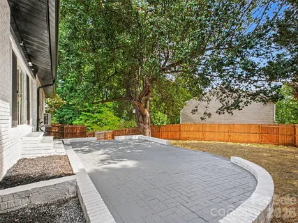 a view of a house with a yard and sitting area