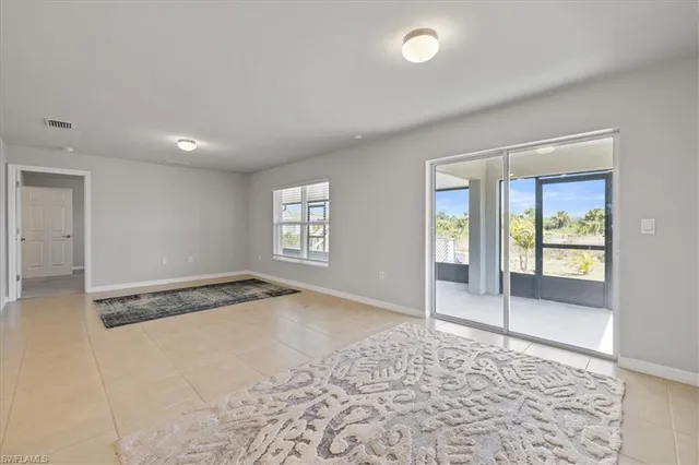 a large white kitchen with kitchen island granite countertop a sink and a stove top oven