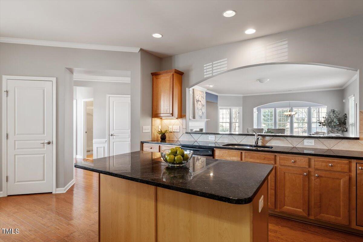 812 Gillinder Place Cary, NC 27519 - Photo 14 of 59 a kitchen with large cabinets a sink dishwasher and a stove with wooden floor