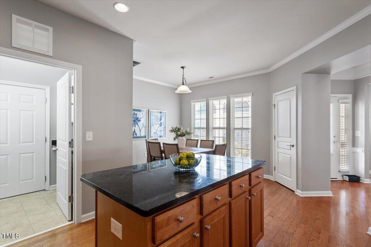 812 Gillinder Place Cary, NC 27519 - Photo 16 of 59 a kitchen with stainless steel appliances granite countertop a sink stove and wooden floor