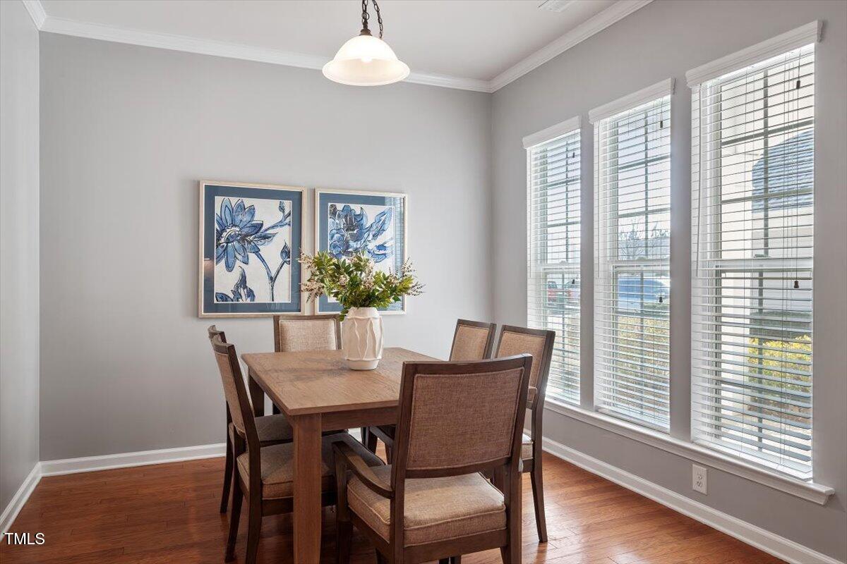 812 Gillinder Place Cary, NC 27519 - Photo 17 of 59 a view of a dining room with furniture and wooden floor