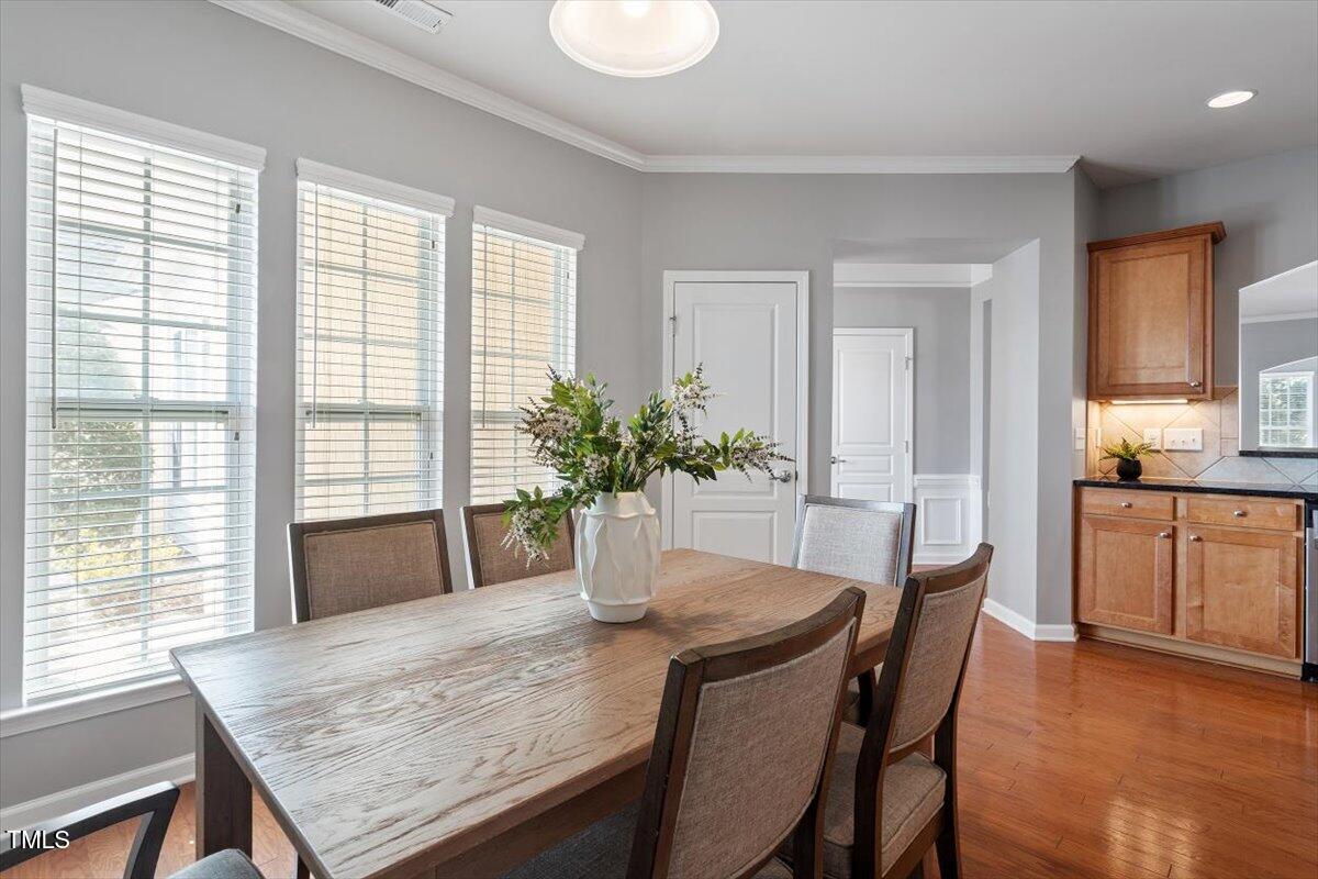 812 Gillinder Place Cary, NC 27519 - Photo 18 of 59 a view of a dining room with furniture and wooden floor