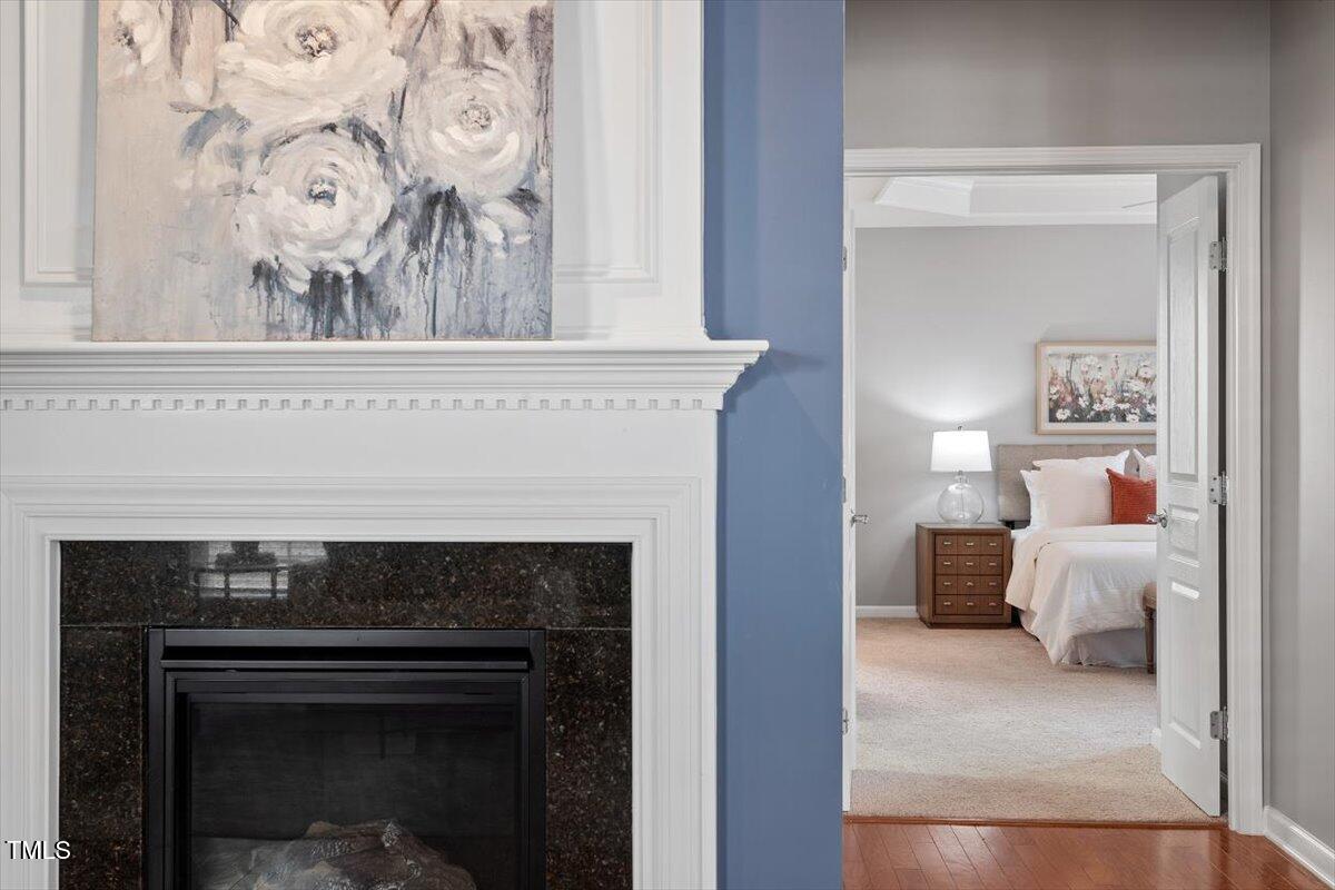812 Gillinder Place Cary, NC 27519 - Photo 20 of 59 a living room with a fireplace and a painting on the wall