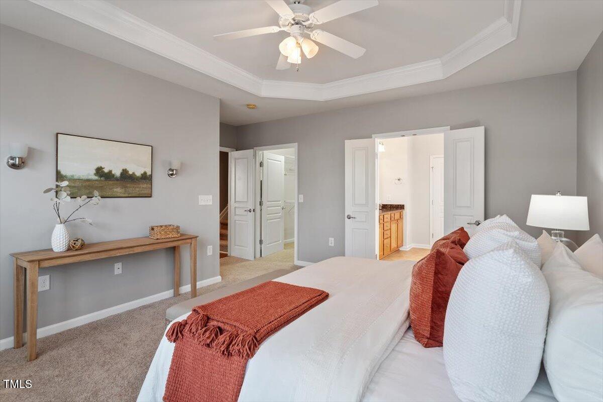 812 Gillinder Place Cary, NC 27519 - Photo 22 of 59 a bedroom with a bed and a chandelier