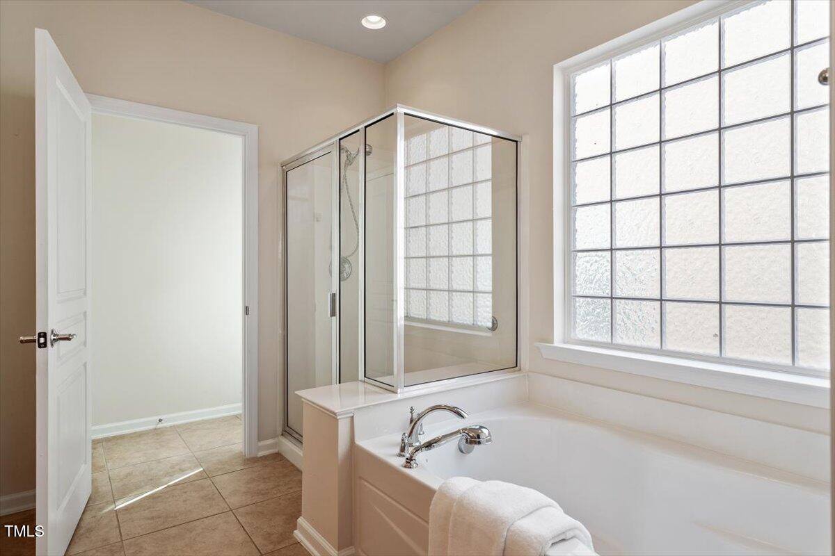 812 Gillinder Place Cary, NC 27519 - Photo 25 of 59 a bathroom with a bathtub and next to a window