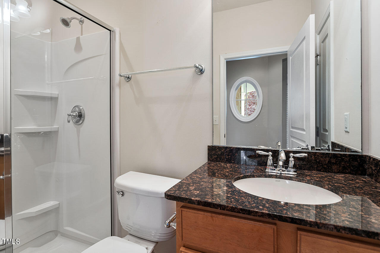 812 Gillinder Place Cary, NC 27519 - Photo 27 of 59 a bathroom with a granite countertop sink and a mirror