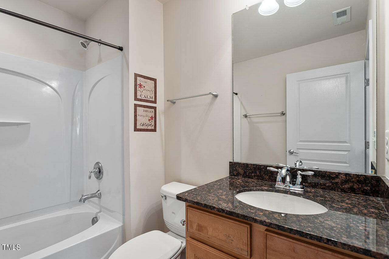 812 Gillinder Place Cary, NC 27519 - Photo 31 of 59 a bathroom with a granite countertop sink toilet and shower