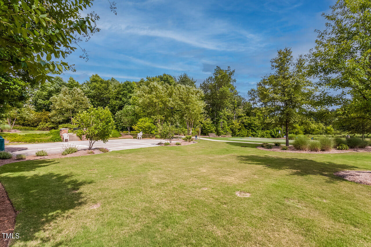 812 Gillinder Place Cary, NC 27519 - Photo 38 of 59 a view of yard with swimming pool and trees in the background
