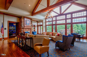 812 Gillinder Place Cary, NC 27519 - Photo 54 of 59 a living room with furniture a fireplace and a large window