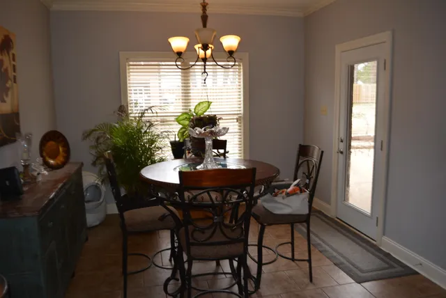 a view of a dining room with furniture and chandelier
