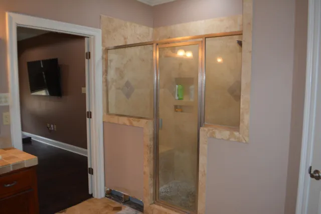 a bathroom with a shower and a sink