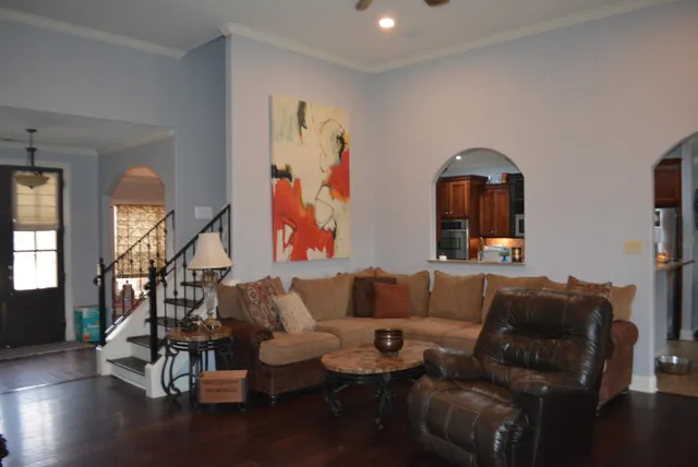 a living room with furniture and wooden floor