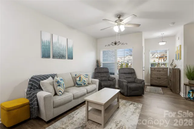 a living room with furniture and a chandelier