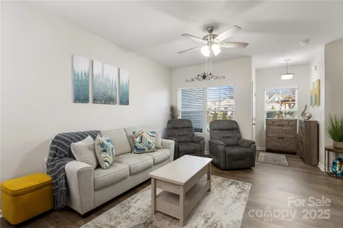 a living room with furniture ceiling fan and a rug