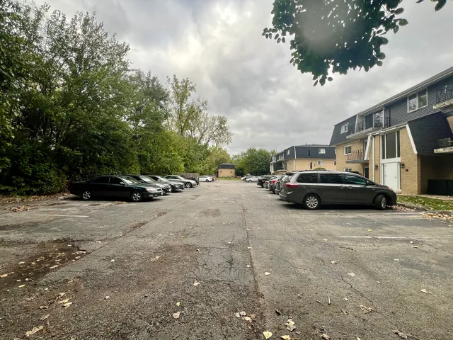a front view of a house with a yard and tree s