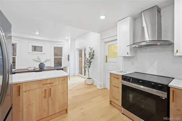 a kitchen with stainless steel appliances granite countertop a stove a sink and a refrigerator