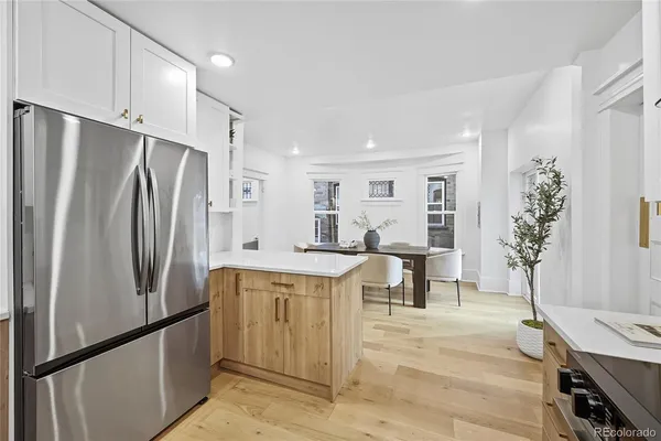 a kitchen with stainless steel appliances a refrigerator and a stove top oven