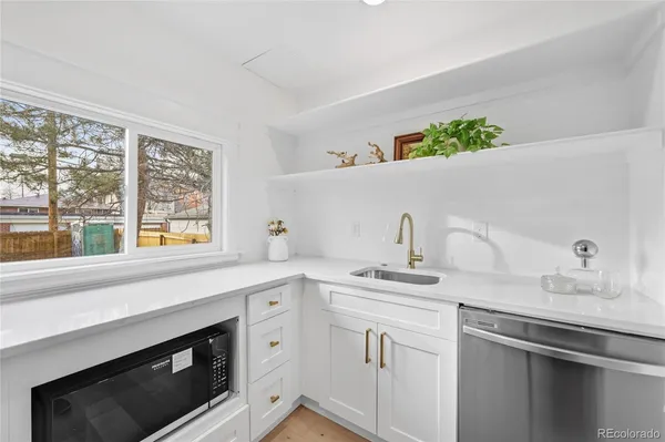 a kitchen with a sink stove and cabinets