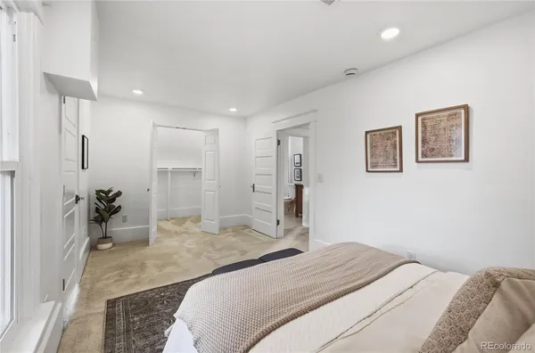 a bedroom with a bed and a large mirror