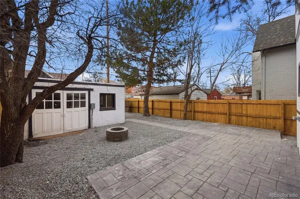 a view of a house with a backyard and a tree