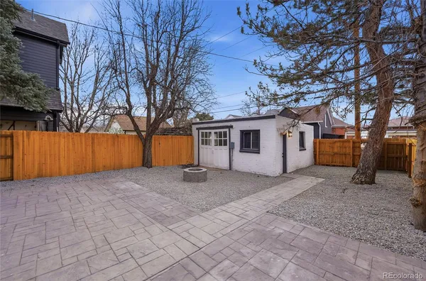 front view of a house with a large tree
