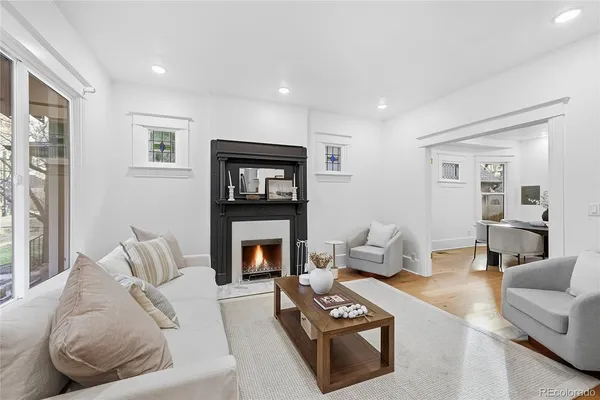 a living room with furniture and a fireplace