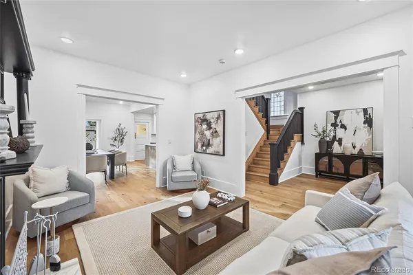 a living room with furniture and a wooden floor