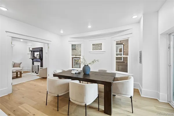 a dining room with furniture and wooden floor