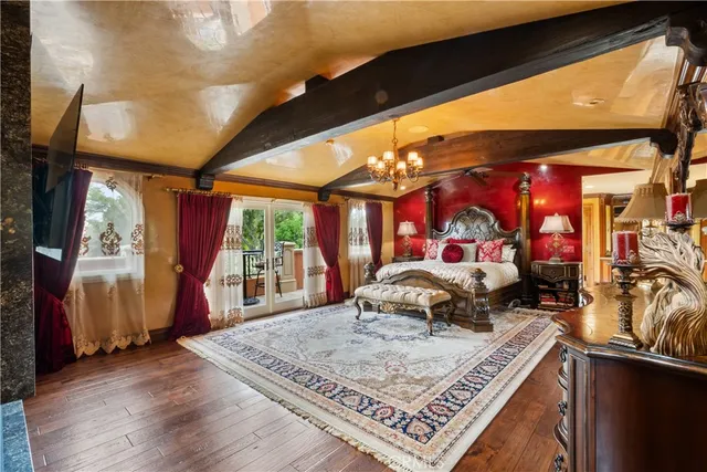 a bedroom with a bed and a large window