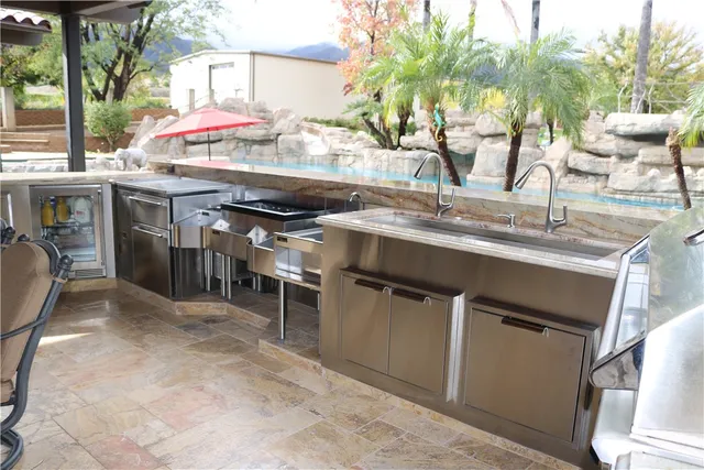 a kitchen with a sink appliances and cabinets