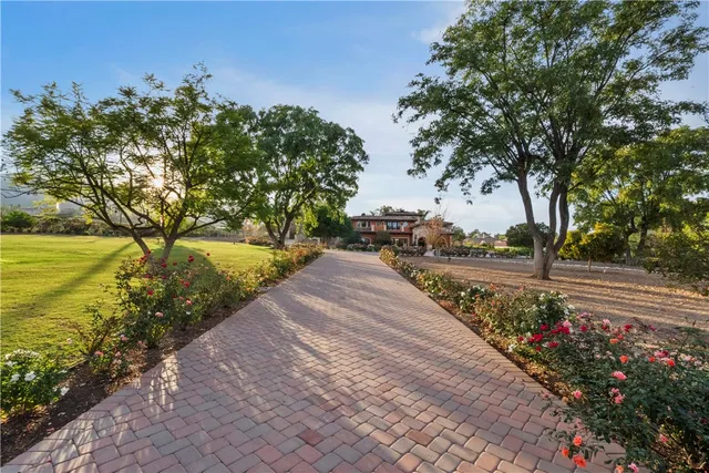 an aerial view of a house with a garden and lake view