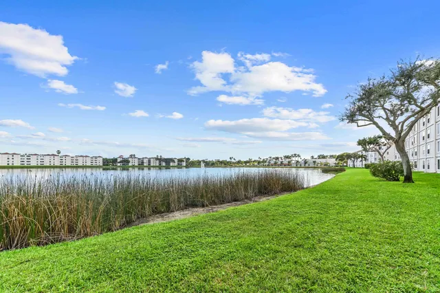 a living room with kitchen island furniture and a chandelier