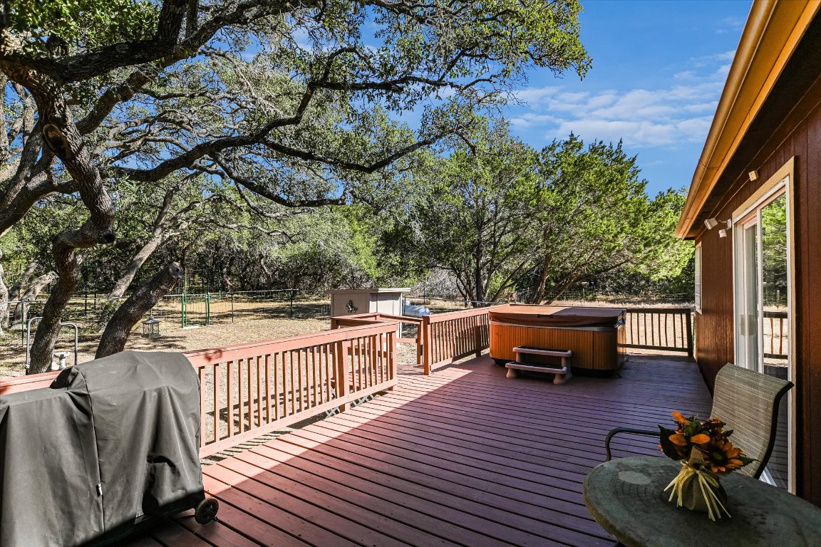 5300 Fischer Store Road Wimberley, TX 78676 - Photo 12 of 20 a view of a chairs and table on the wooden deck