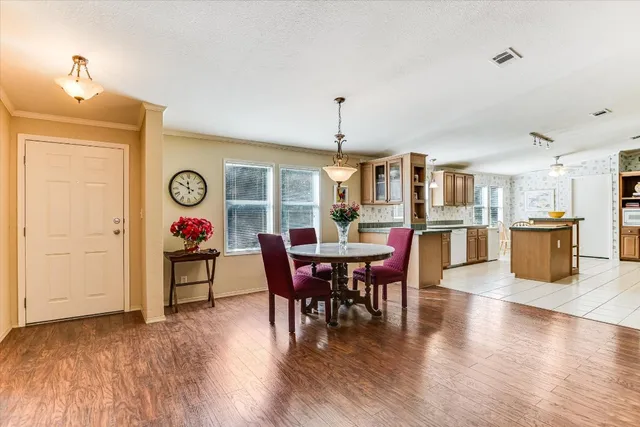 a view of a dining room with furniture and wooden floor