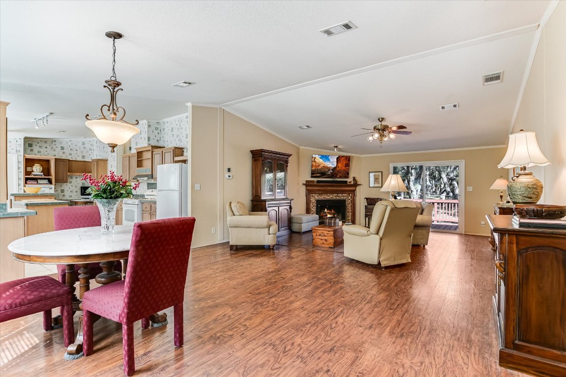 5300 Fischer Store Road Wimberley, TX 78676 - Photo 4 of 20 a living room with fireplace furniture and a wooden floor
