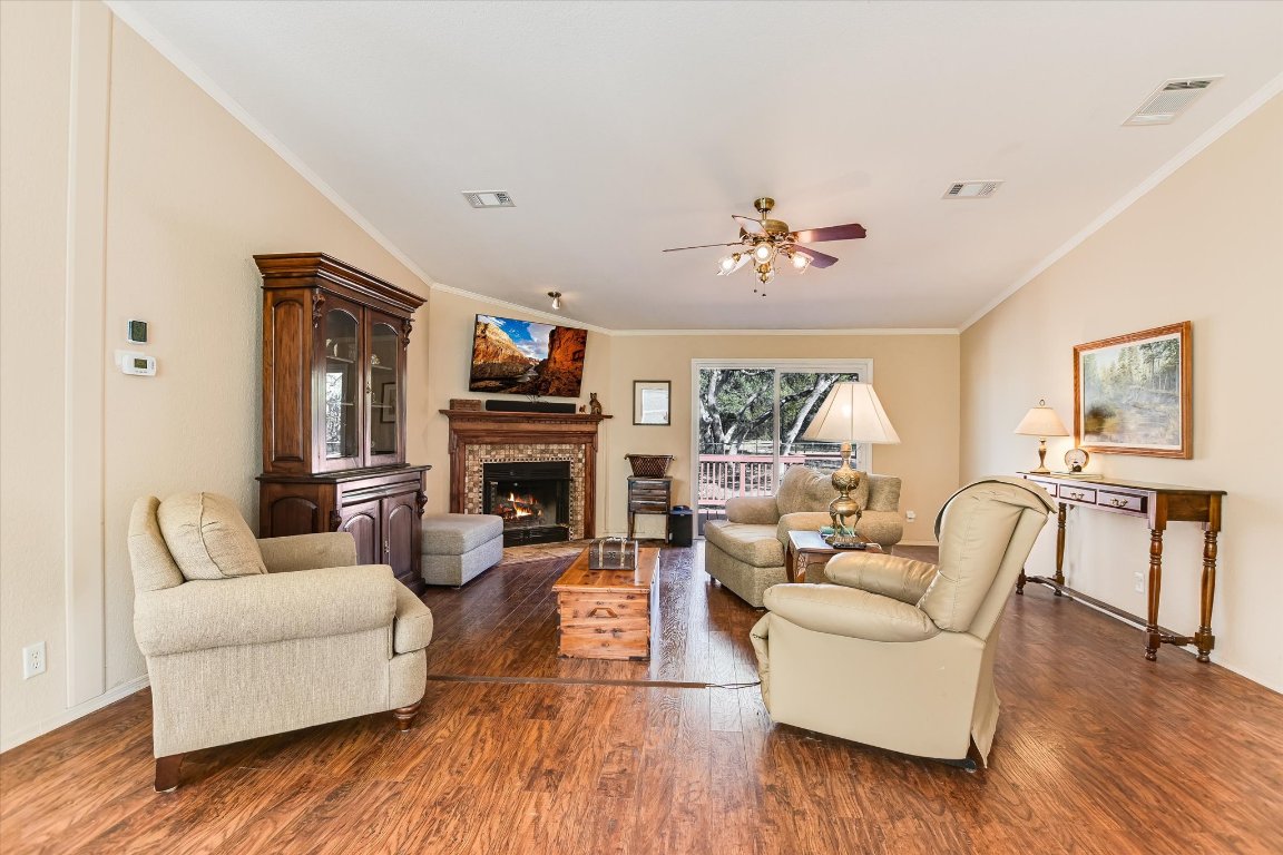 5300 Fischer Store Road Wimberley, TX 78676 - Photo 5 of 20 a living room with furniture a fireplace and a flat screen tv