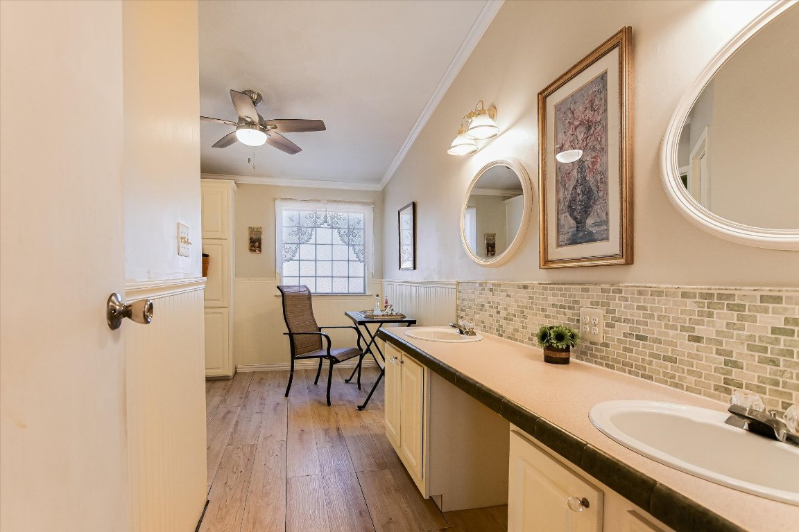 5300 Fischer Store Road Wimberley, TX 78676 - Photo 9 of 20 a bathroom with a granite countertop double vanity sink and a mirror