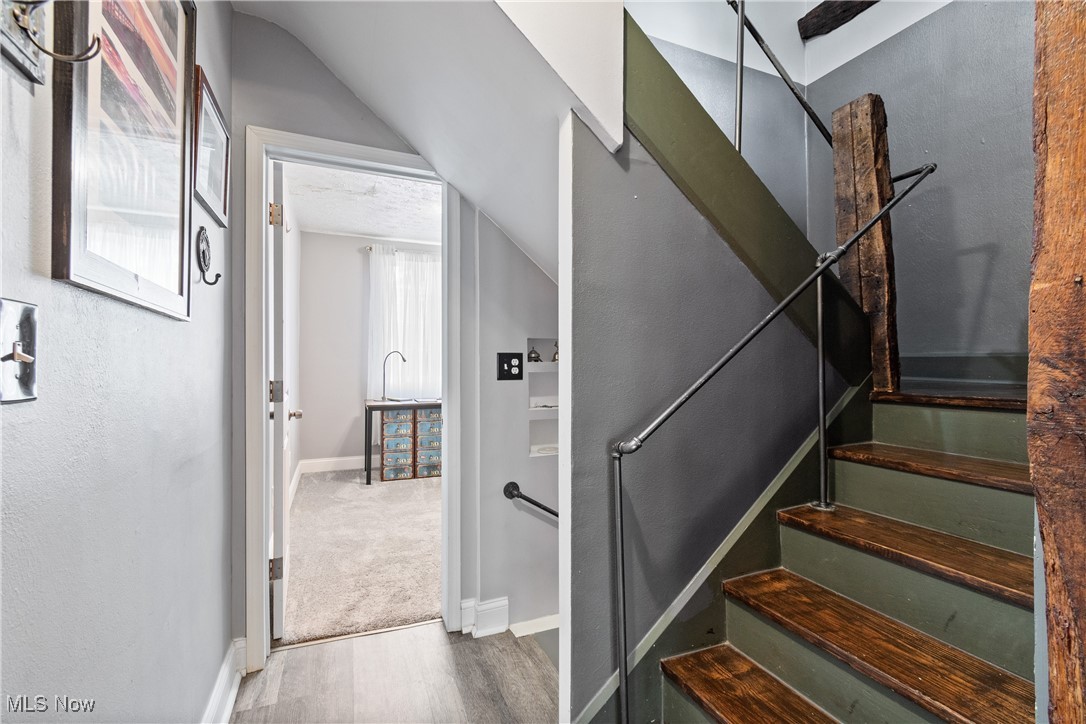 4786 Mayfair Road North Canton, OH 44720 - Photo 18 of 38 Staircase featuring wood finished floors and a textured wall