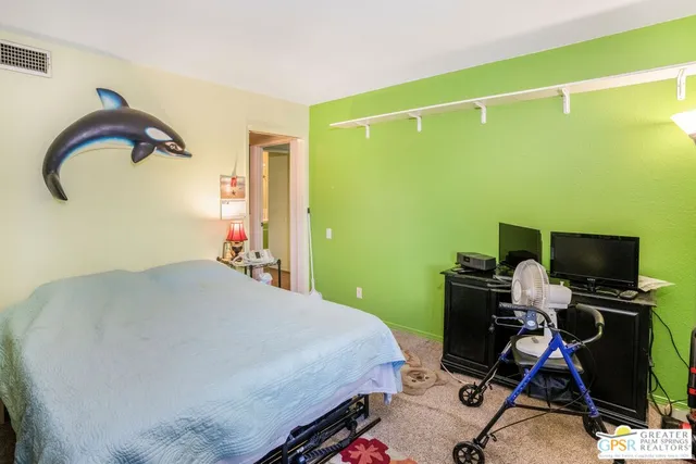 a bedroom with a bed and a mirror