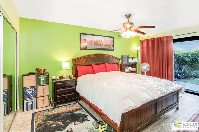 a bedroom with a bed and a bookshelf