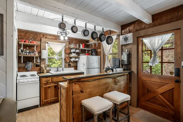 a view of a dining room with furniture a chandelier and window