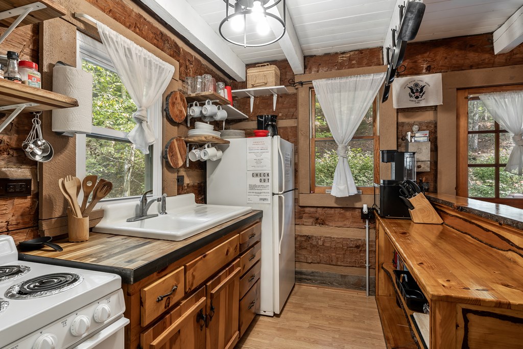 151 Pinewood Drive Murphy, NC 28906 - Photo 13 of 43 a kitchen that has a stove and a wooden floor