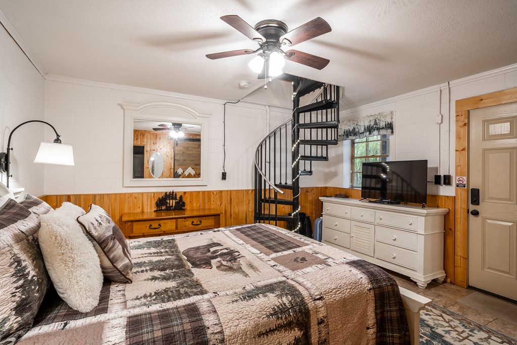 151 Pinewood Drive Murphy, NC 28906 - Photo 17 of 43 a bedroom with a large bed and a chandelier
