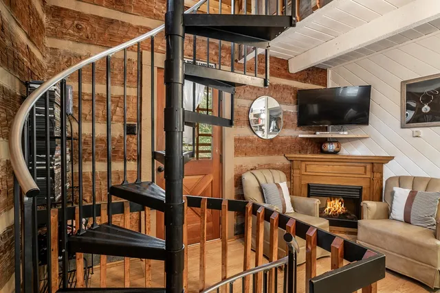 a living room with furniture fireplace and flat screen tv