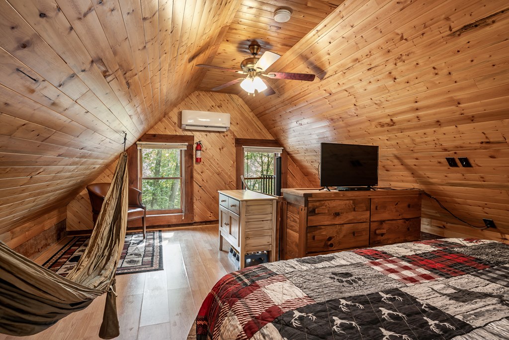 151 Pinewood Drive Murphy, NC 28906 - Photo 24 of 43 a bedroom with a bed and flat screen tv