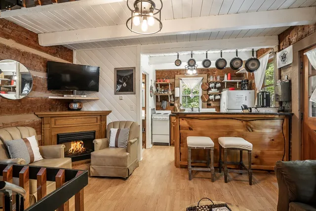 a living room with fireplace furniture and a flat screen tv